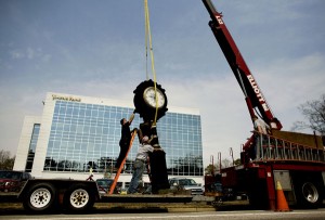 Workers from Artlite Signs & Awnings get ready to move the Hardy's Jewellers clock onto its new foundation on 21st Street near Mediterranean Avenue in Virginia Beach. The clock's pedestal was designed in 1884. (Todd Spencer | The Virginian-Pilot)